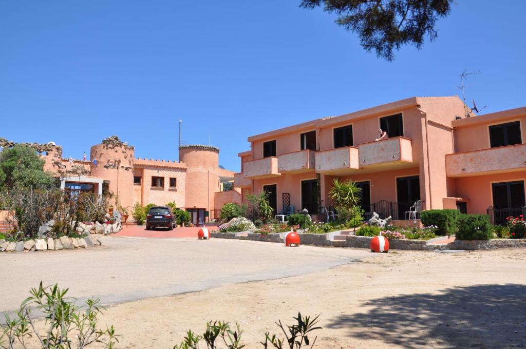 a parking lot in front of a building at Hotel Le Dune IUN 1998 in Porto Pollo