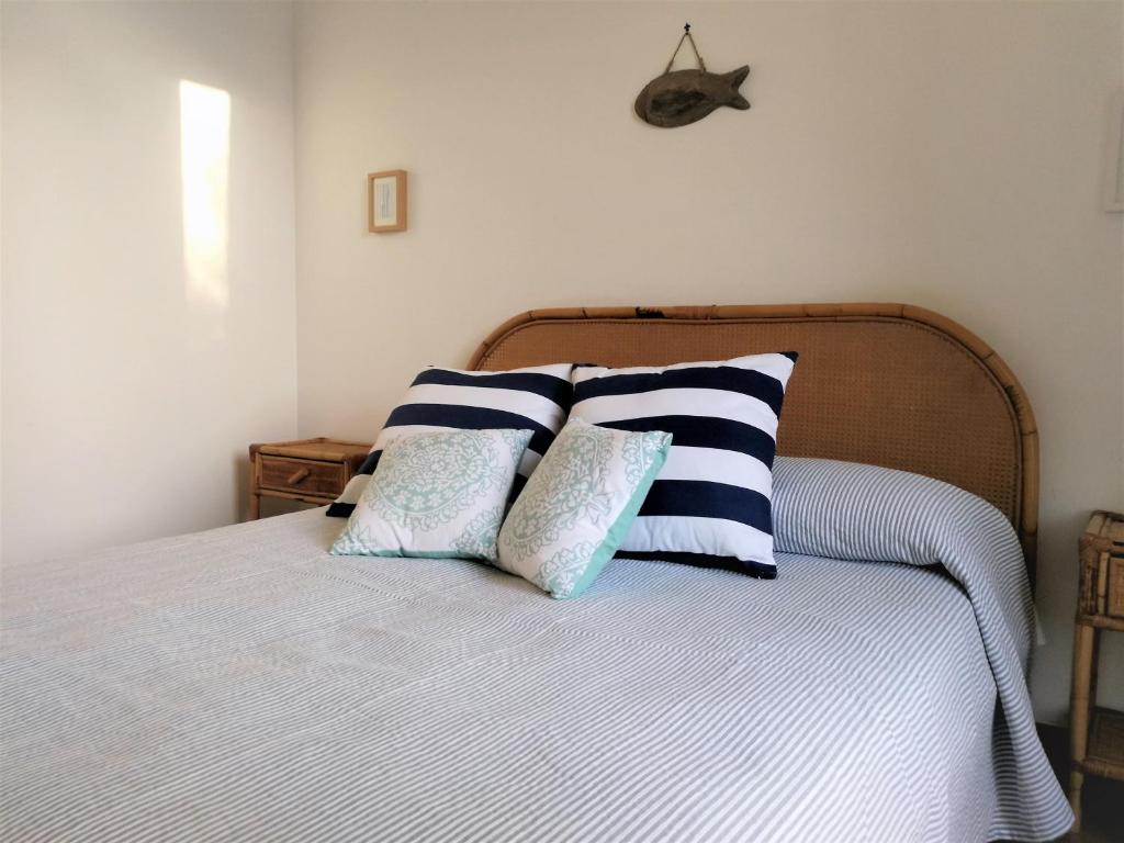 a bedroom with a bed with blue and white pillows at Casa vista Mare in Torre Canne