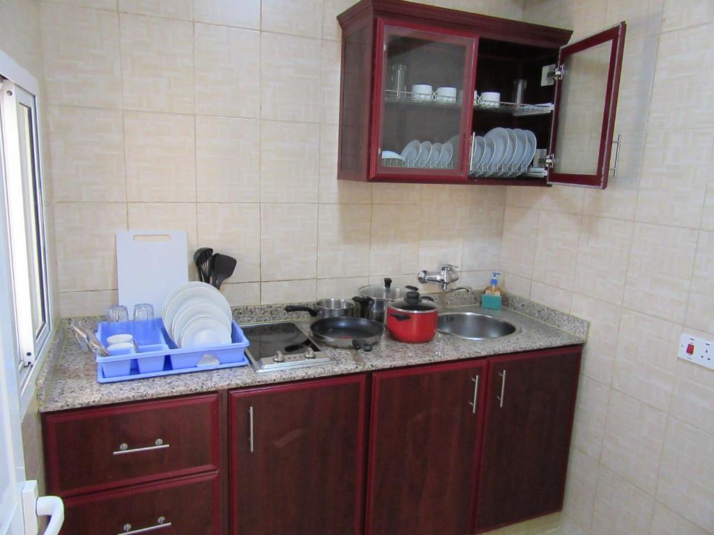 Kuchyň nebo kuchyňský kout v ubytování Al Ferdous Hotel Apartments