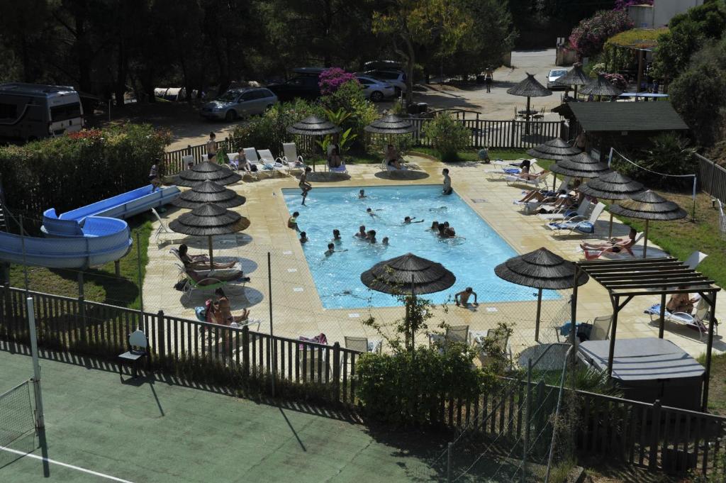 an overhead view of a swimming pool with people in it at Camping Torraccia in Cargèse