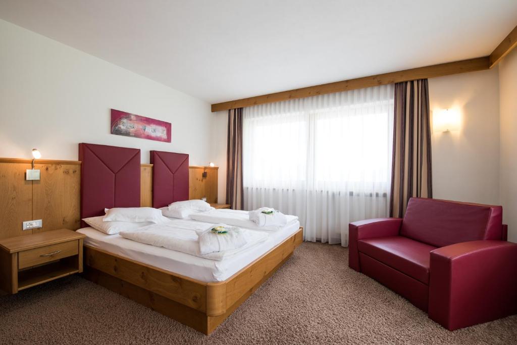 Postel nebo postele na pokoji v ubytování Garni Hotel Bel Vert