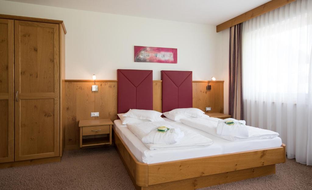 Postel nebo postele na pokoji v ubytování Garni Hotel Bel Vert