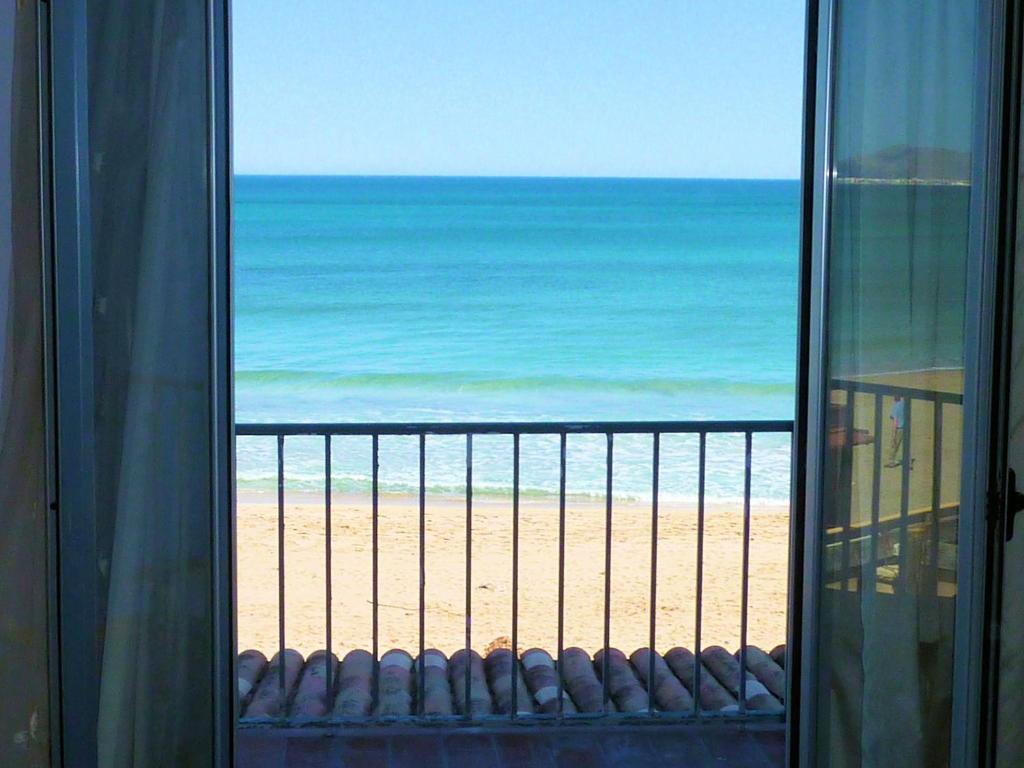 a view from a balcony of a beach with a view of the ocean at Hotel Sa Roqueta Can Picafort in Can Picafort