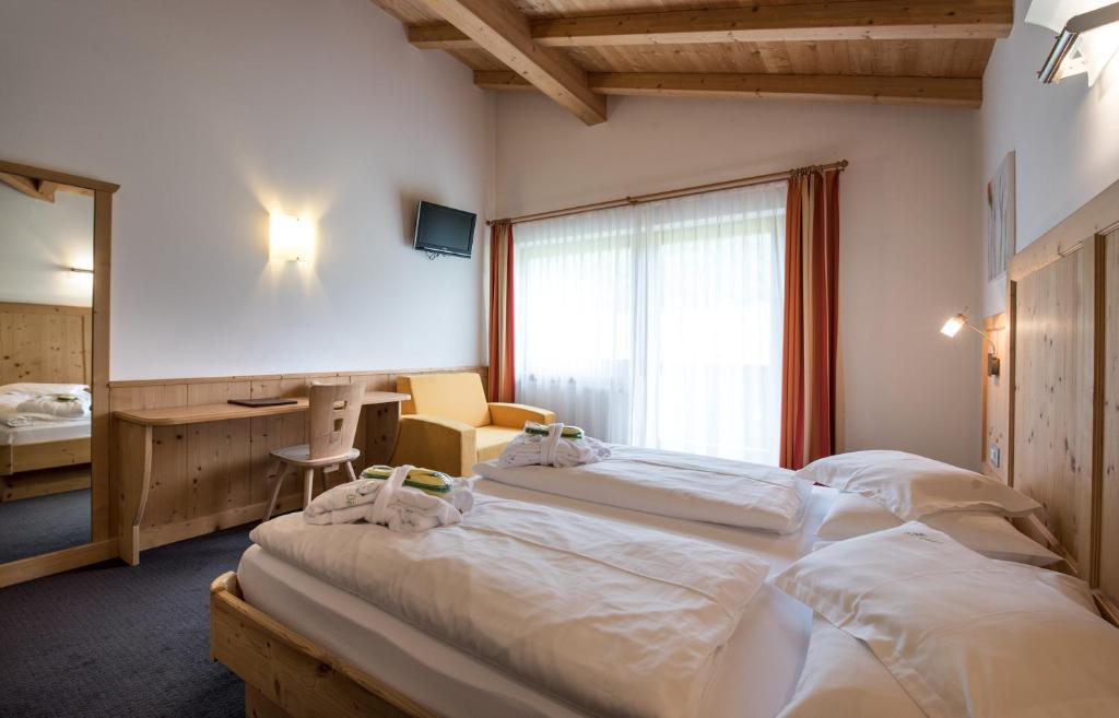 Postel nebo postele na pokoji v ubytování Garni Hotel Bel Vert
