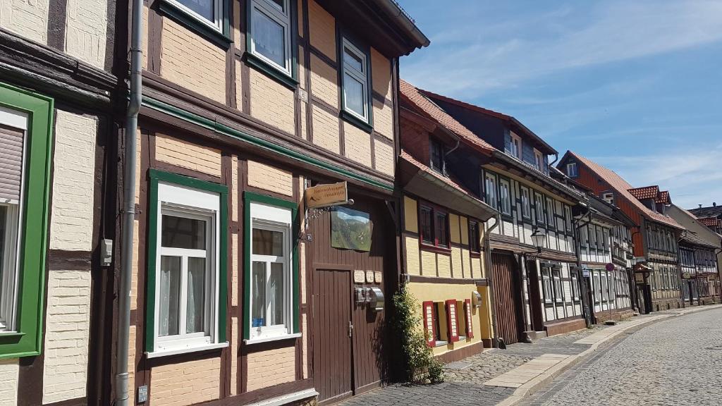 a row of wooden buildings on a street at Ferienwohnung Altstadtidylle 2 in Wernigerode