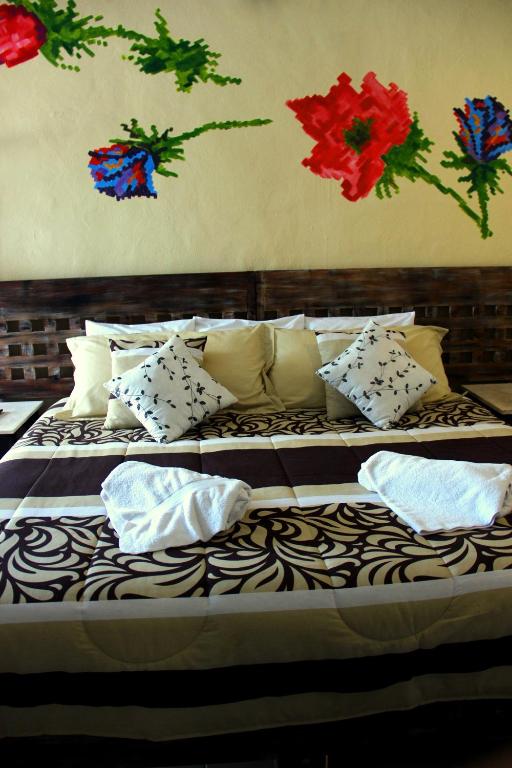 Postel nebo postele na pokoji v ubytování Casa Akbal B&B