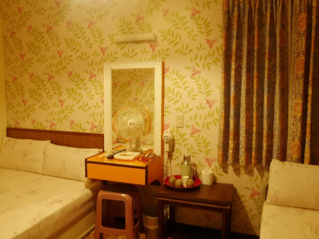 Postel nebo postele na pokoji v ubytování Ku Shan Yuan Hotel