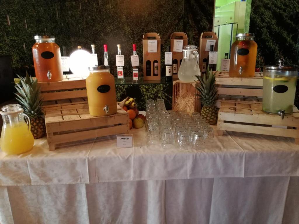 a table with glasses and bottles of juice on it at Hotel Vinotel Gospoja in Vrbnik
