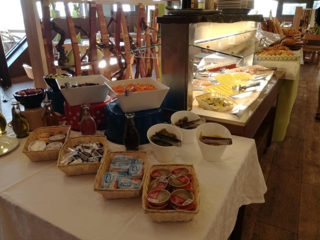 a table with many different types of food on it at Hotel Vinotel Gospoja in Vrbnik