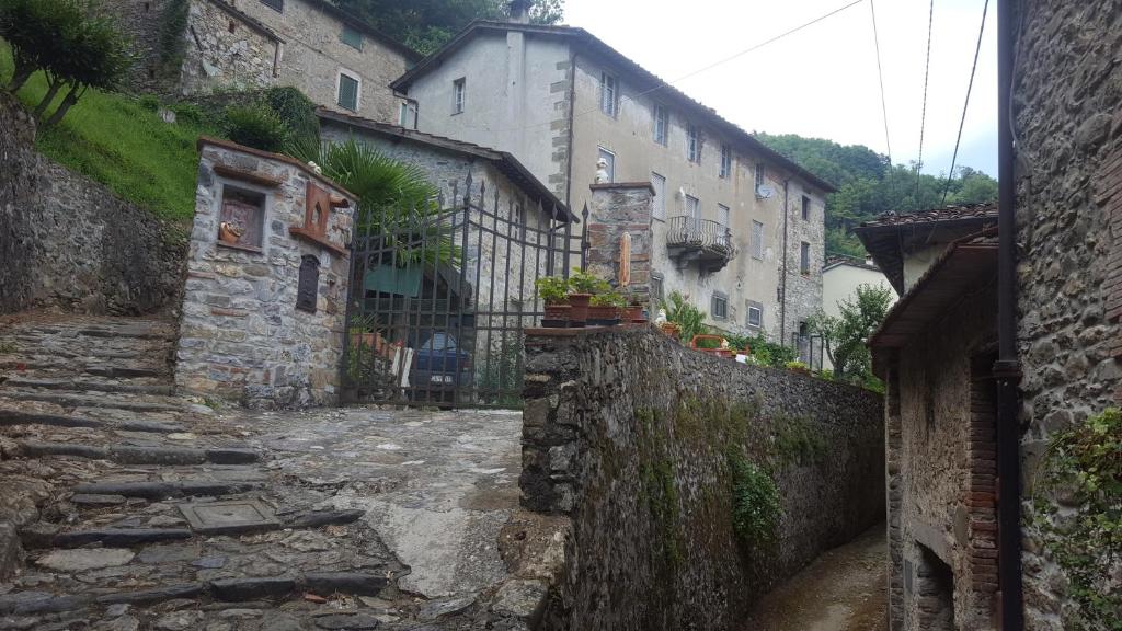 an alley in a village with stone buildings at Affittacamere Ferrari in Pescaglia