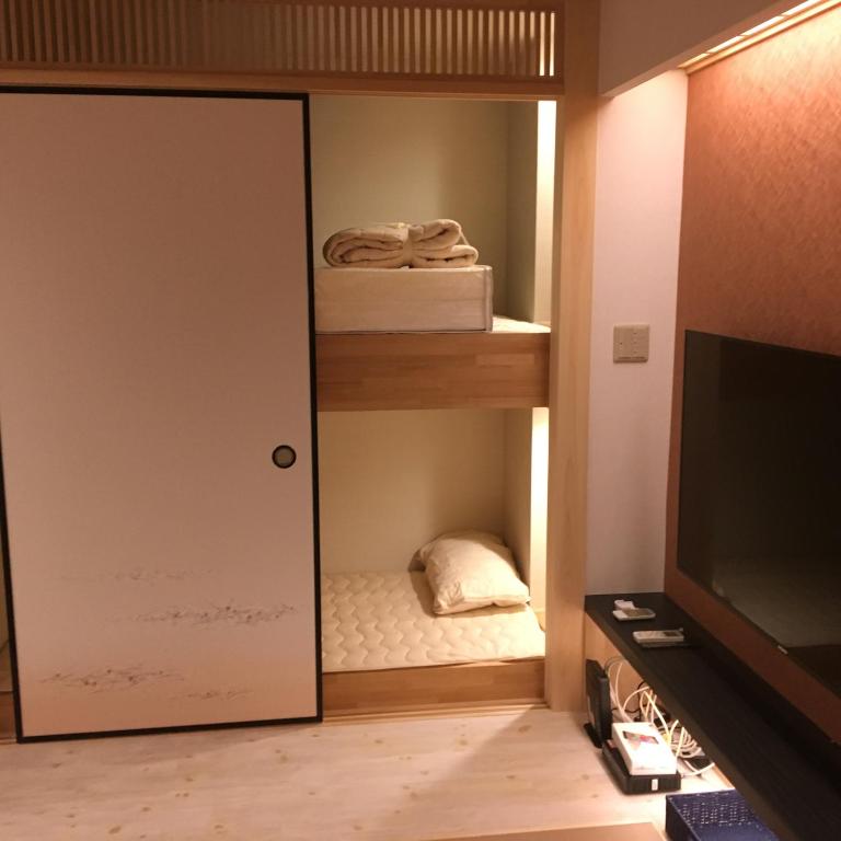 a room with a closet with a door and a bed at Tokyo inn Sakura An in Tokyo