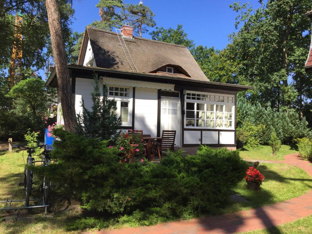 a white house with a gambrel roof at Bungalow Beachhouse in Boltenhagen