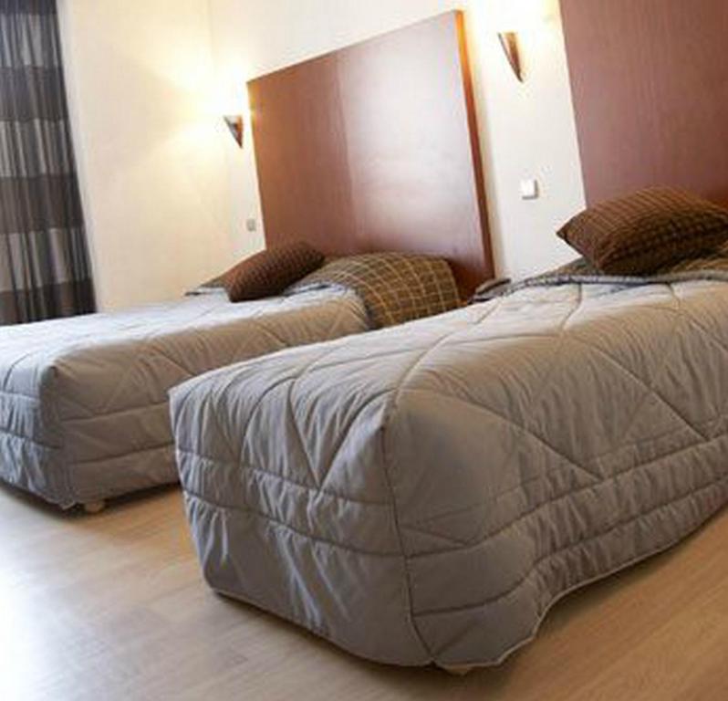 Postel nebo postele na pokoji v ubytování Logis Hôtel Le Cheval Blanc
