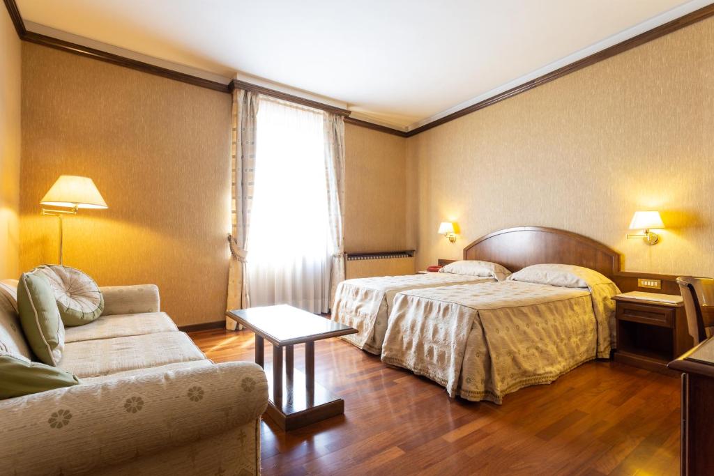 Postel nebo postele na pokoji v ubytování Albergo Il Cacciatore