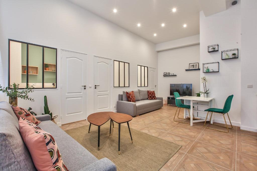 a living room with a couch and a table at 66 - Atelier Fidélité Paris in Paris