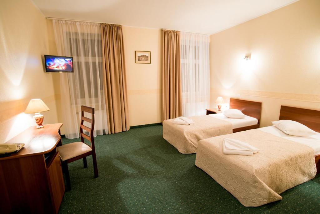 Postel nebo postele na pokoji v ubytování Dinaburg SPA Hotel