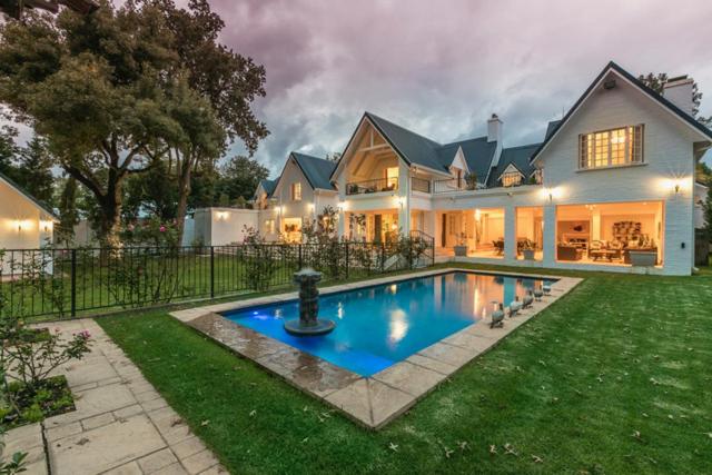 a large house with a swimming pool in the yard at Oxford Healthcare Retreat in Johannesburg