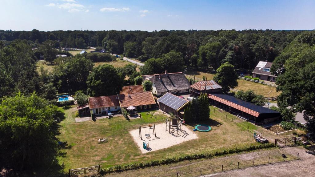 an aerial view of a house with a playground at De Heidehoeve in Wezep