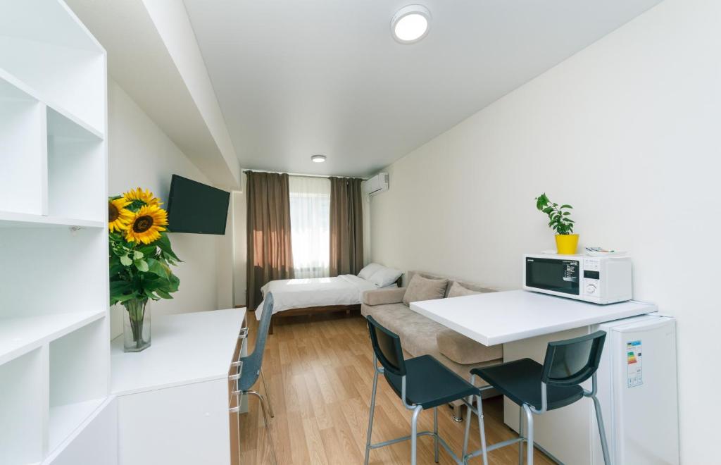 a room with a kitchen and a living room at Inn Kiev in Kyiv