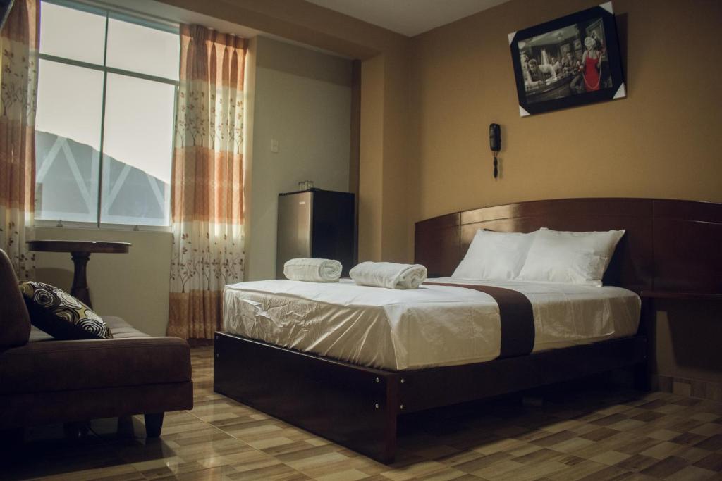 a bedroom with a large bed and a window at Hotel Real Chimbote in Chimbote