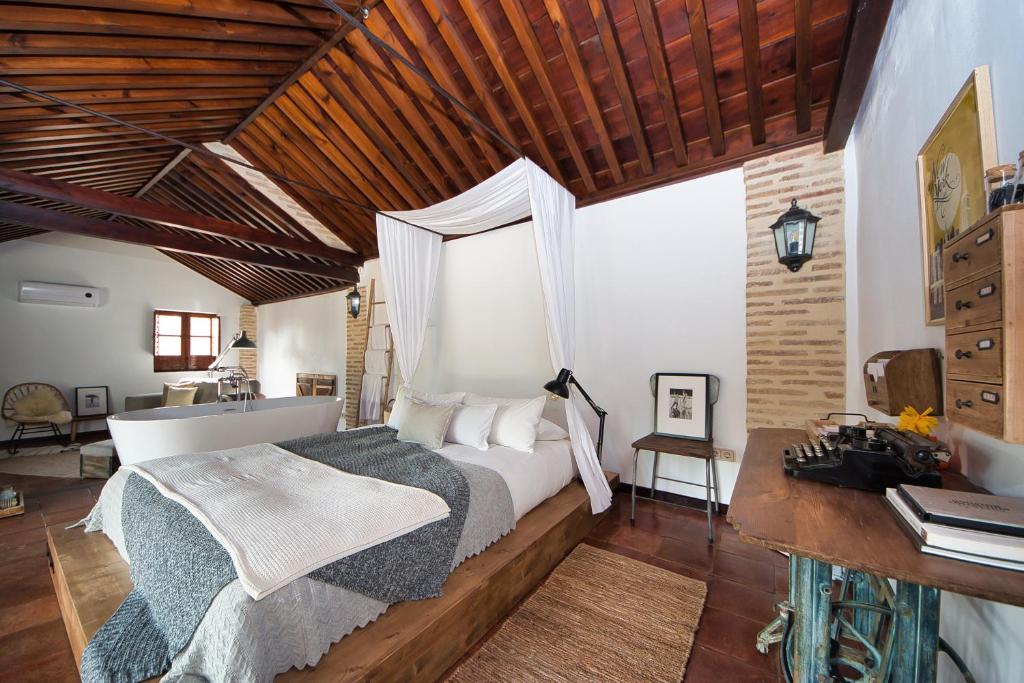 a bedroom with a bed and a wooden ceiling at The Lovers Boutique in Granada