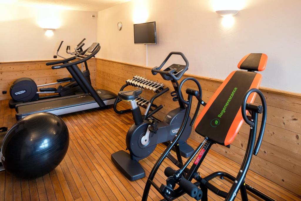 a gym with two exercise bikes and a treadmill at Carlina in La Clusaz