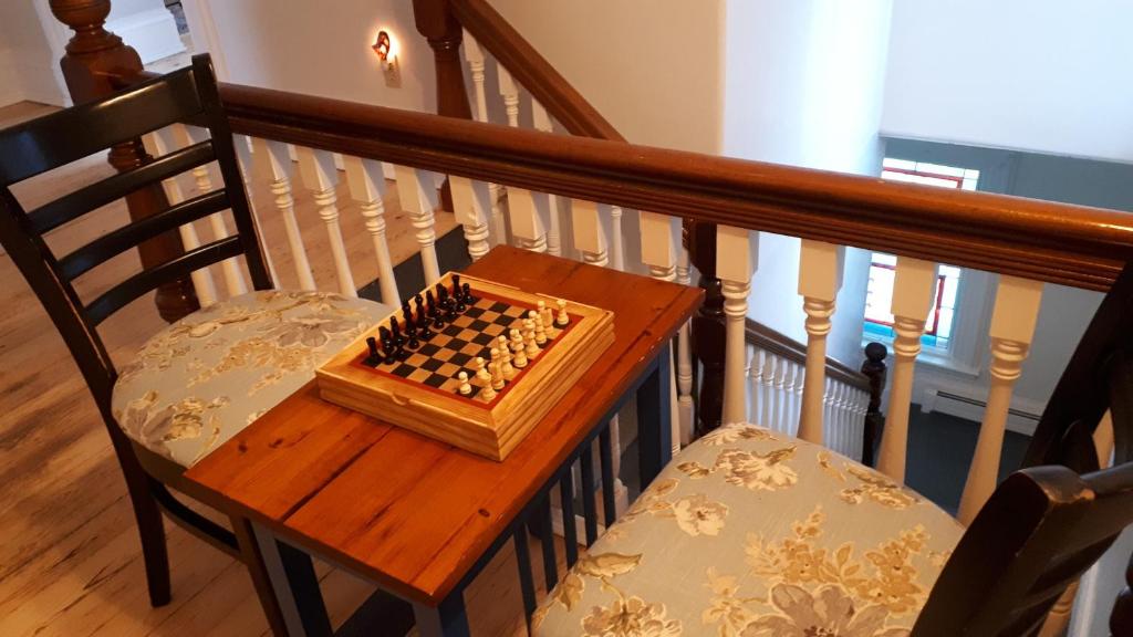 a wooden chess board on a chair on a staircase at Hillside Landing B&B in Digby