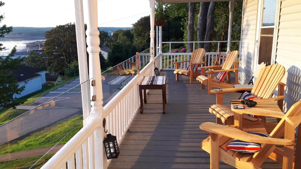 a porch with rocking chairs on a house at Hillside Landing B&B in Digby