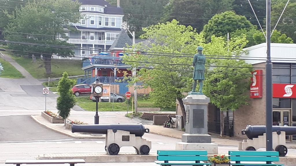a statue of a man on a pedestal with benches at Hillside Landing B&B in Digby