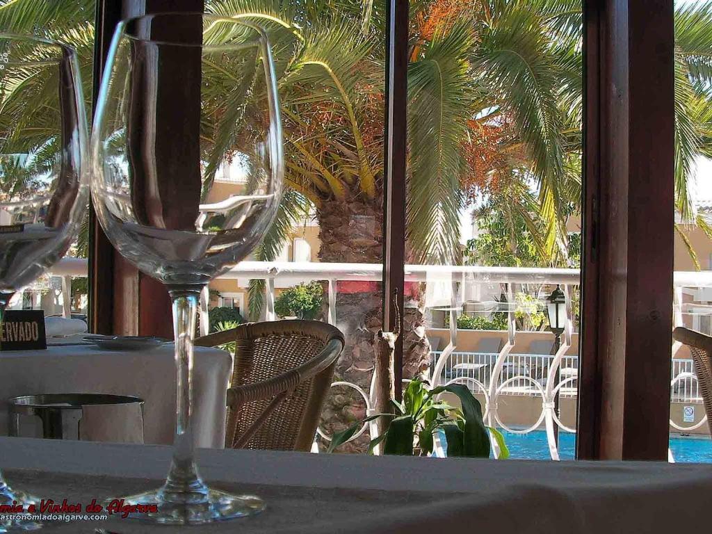 a wine glass sitting on top of a table at Pestana Palm Gardens in Carvoeiro