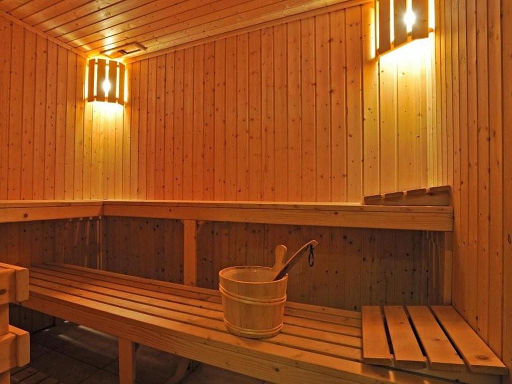 an inside of a sauna with a bucket in it at Pestana Palm Gardens in Carvoeiro