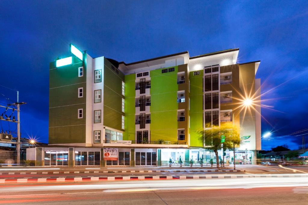 a building on a city street at night at Je T'aime Hotel in Trang