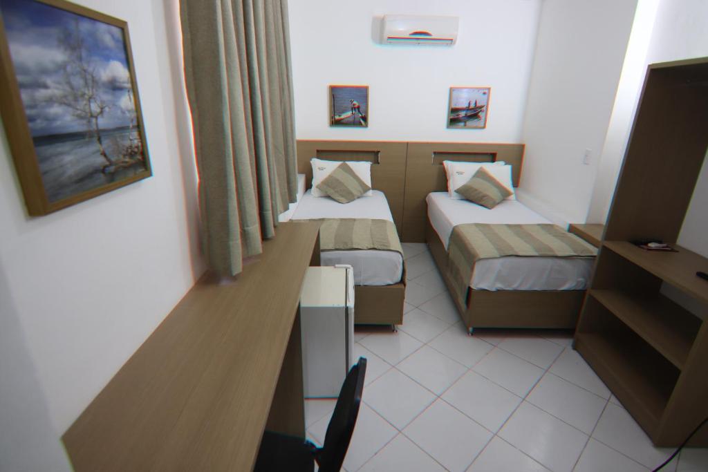 Postel nebo postele na pokoji v ubytování Hotel Dom Passos