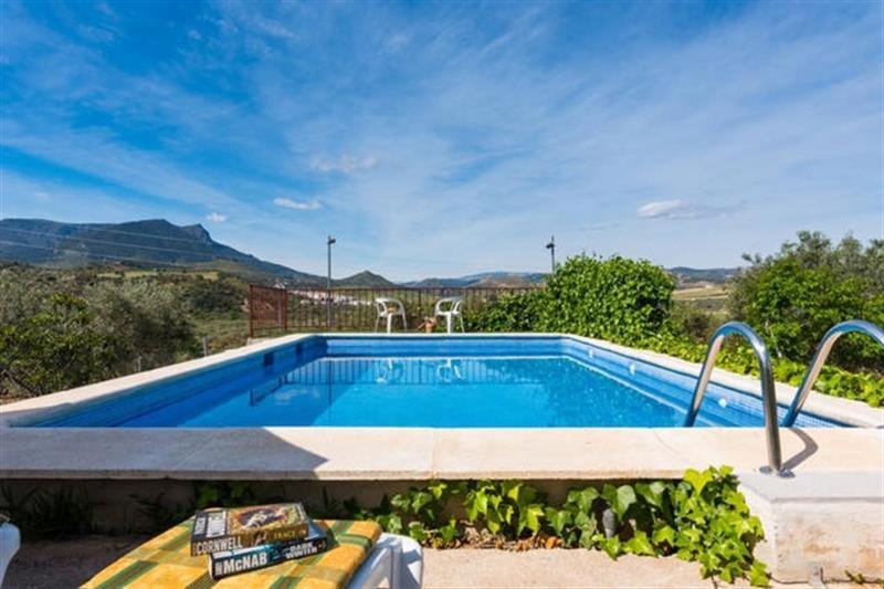 a swimming pool with a view of the mountains at Rural El Puerto Mayordomo in Ardales