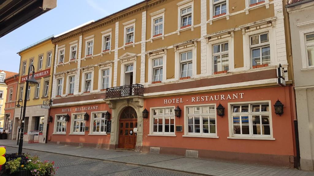 a building on a street in a city at Hotel Sachsenhof in Riesa