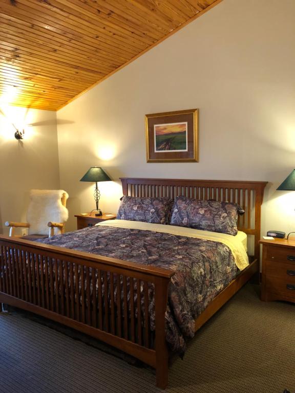 a bedroom with a large bed and a wooden ceiling at ReWild Ranch LLC in Sargent