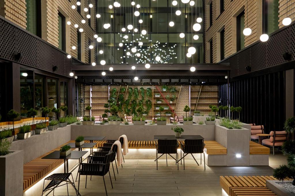 a restaurant with tables and chairs in a building at PURO Kraków Kazimierz in Krakow