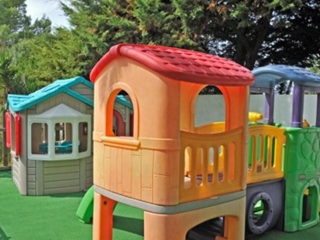 a toy train on a playground with other toys at Pestana Palm Gardens in Carvoeiro