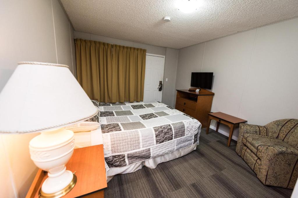 Postel nebo postele na pokoji v ubytování Olympia Lodge