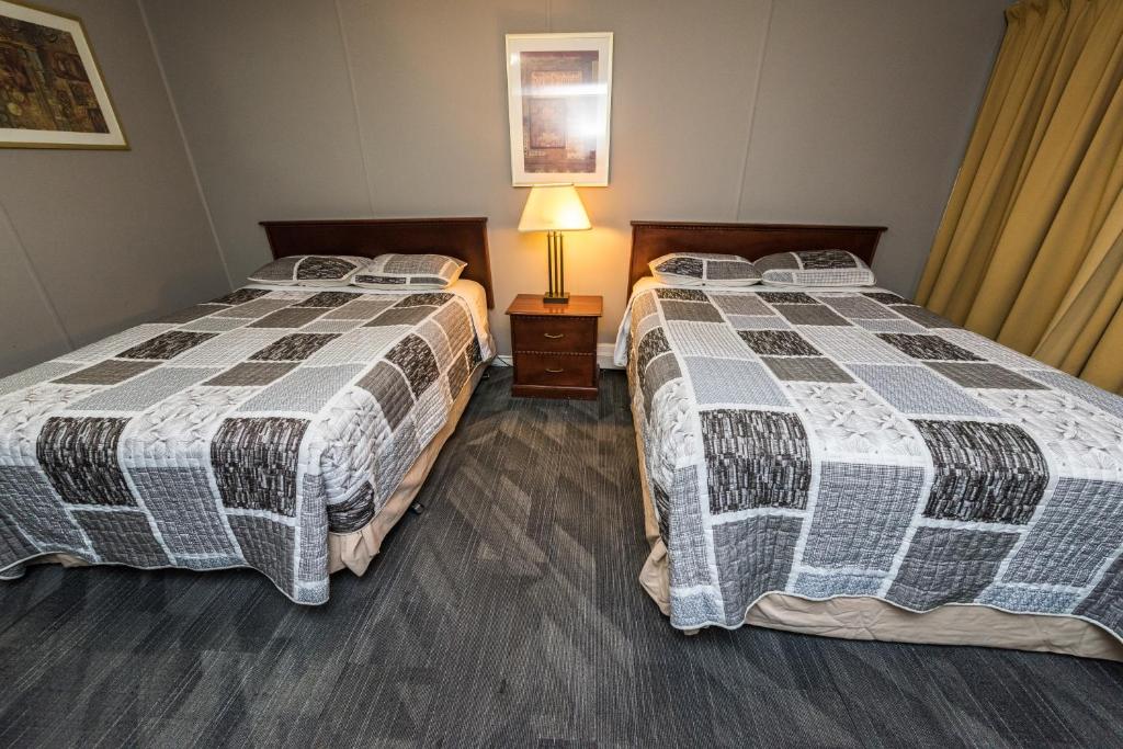 Postel nebo postele na pokoji v ubytování Olympia Lodge