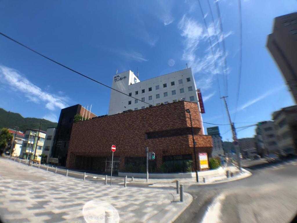 a building on the corner of a city street at Hotel Crown Hills Kamaishi in Kamaishi