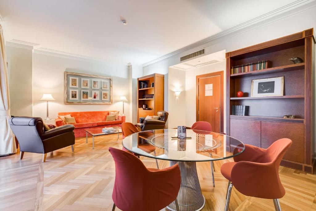 a living room with a glass table and chairs at Villa Maria Hotel & SPA in Francavilla al Mare