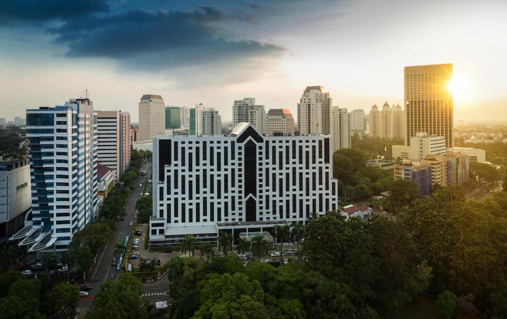a large white building in the middle of a city at ARTOTEL Gelora Senayan Jakarta in Jakarta