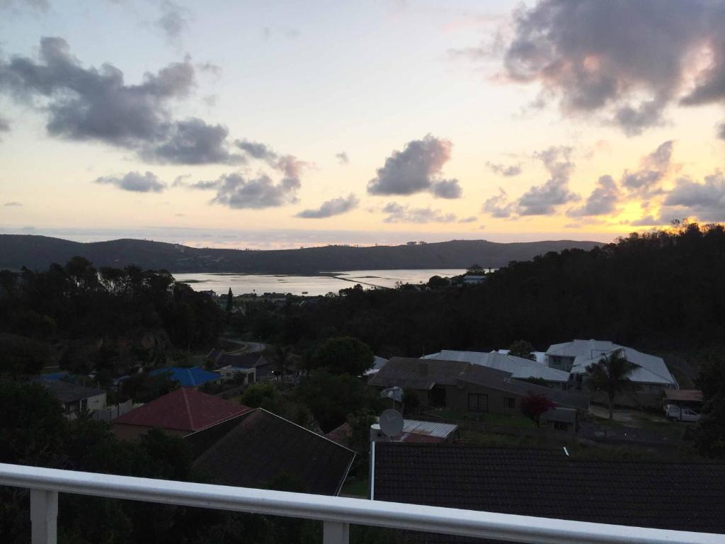 a view from a balcony of a city with a sunset at 3 Oaklands on the Knoll in Knysna
