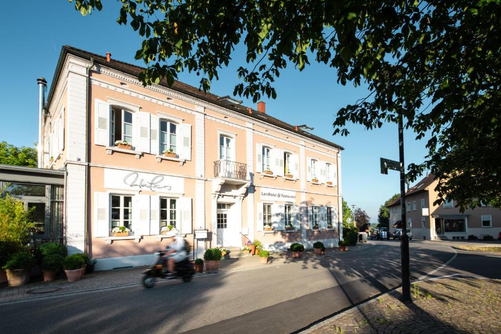 a person riding a scooter in front of a building at Landhotel & Restaurant Walsers in Efringen-Kirchen