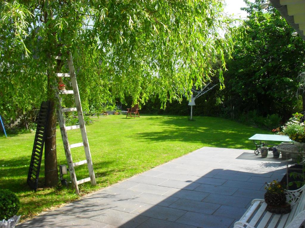 a ladder leaning against a tree next to a park at Villa Jani b&amp;b in Breitscheid