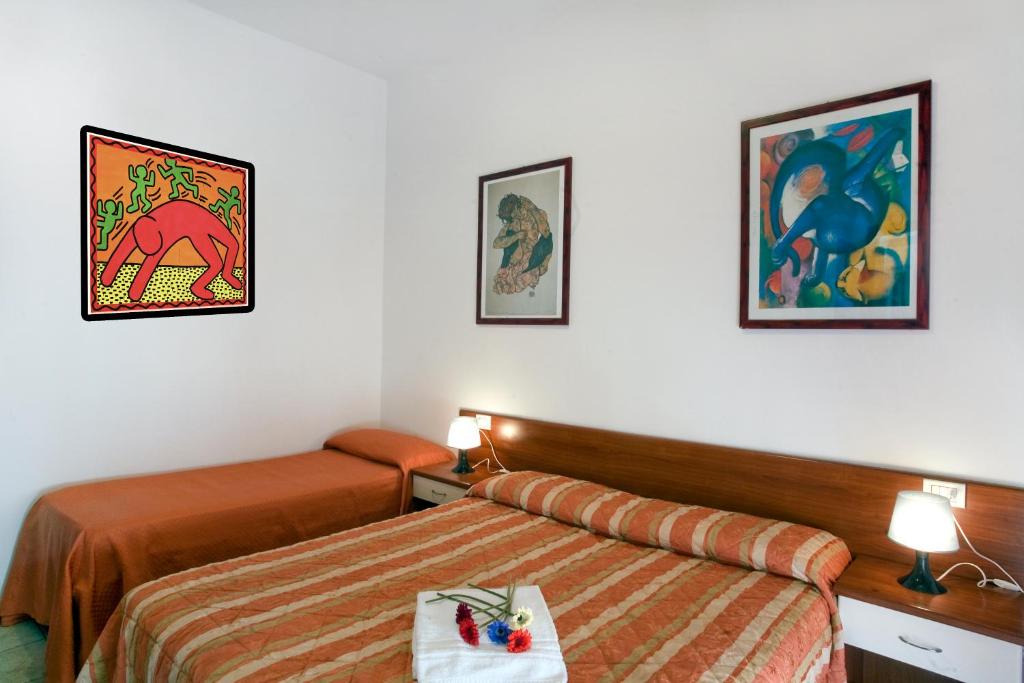 a hotel room with two beds in a room at Residence Auriga in Rimini