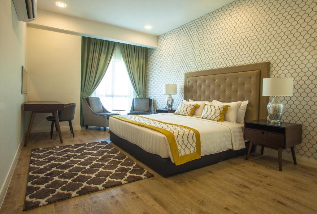 Postel nebo postele na pokoji v ubytování RPGC Garden Hotel