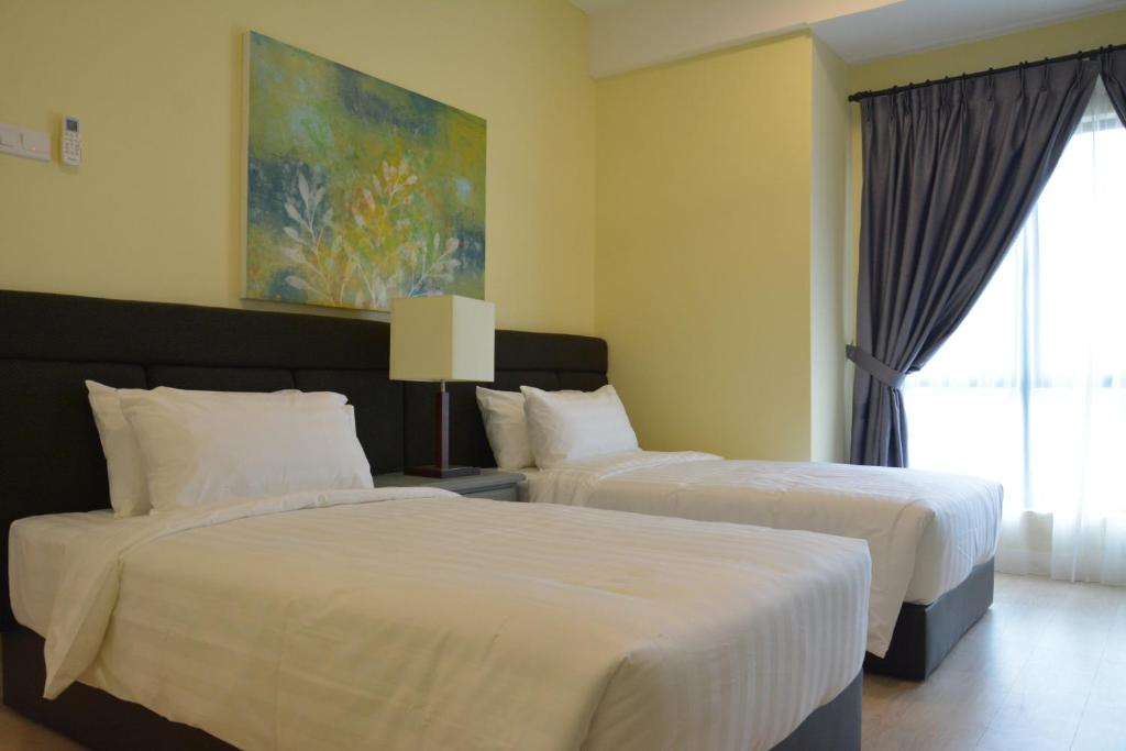 Postel nebo postele na pokoji v ubytování RPGC Garden Hotel