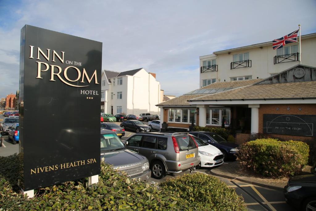 a sign in front of a parking lot with cars at Inn On The Prom At The Fernlea Hotel in Lytham St Annes